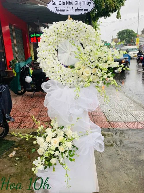 Vòng hoa đám tang tông màu trắng gồm hoa lan, hoa cúc, hoa hồng.
